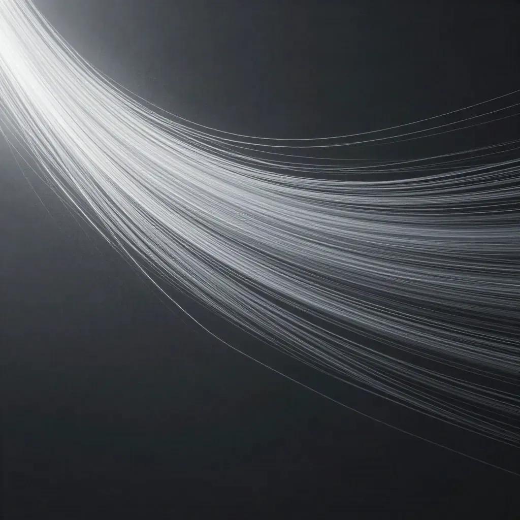 Silver filaments converge into a soft white bloom in a dark graphite void with haze and motes.